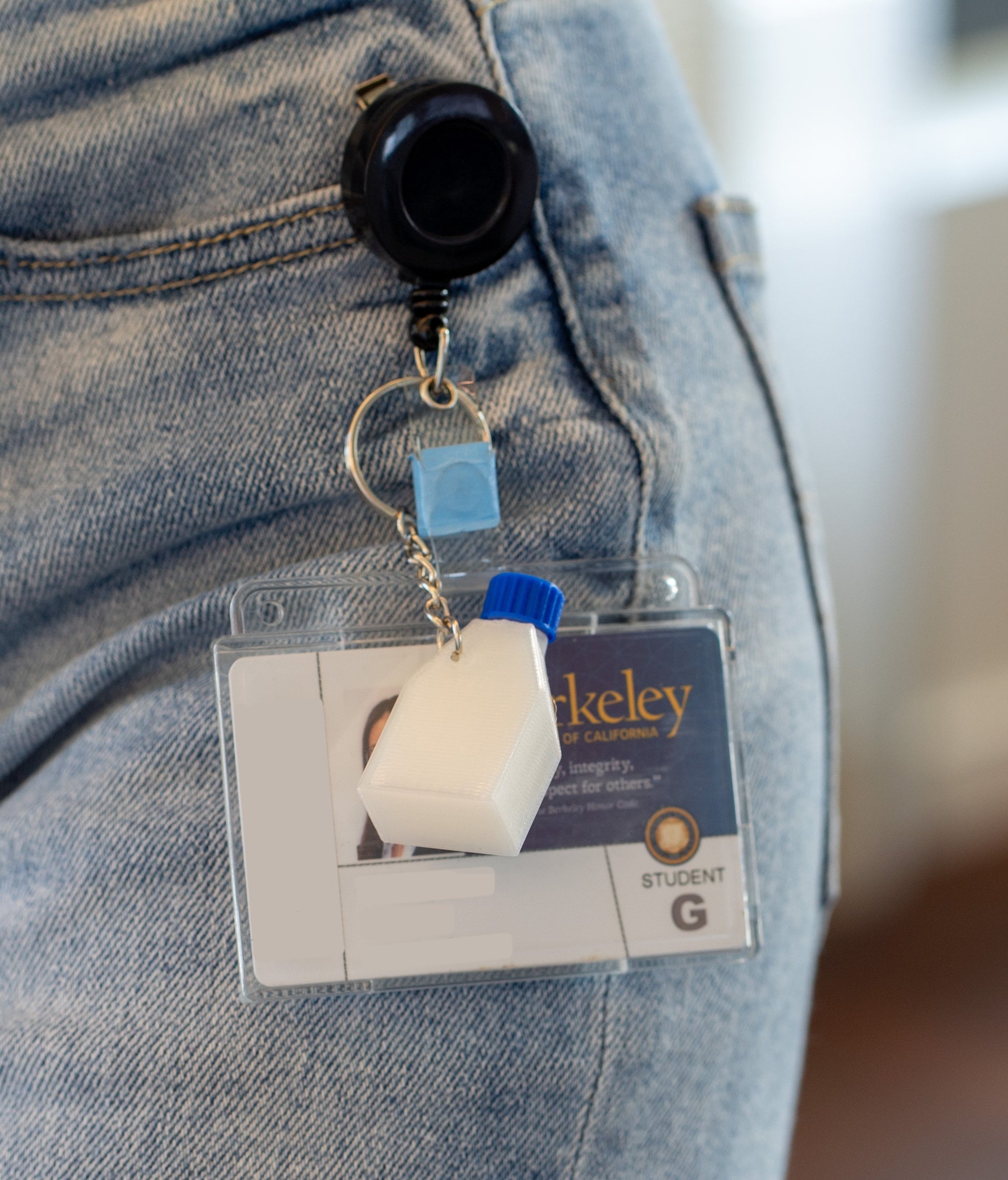 Retractable badge holder and ID with a miniature culture flask keychain with a blue cap